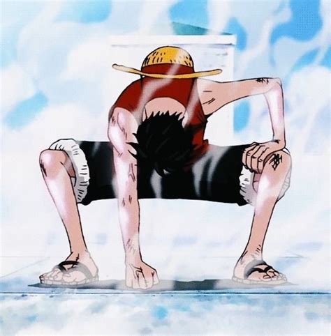 A Man Sitting On Top Of A Skateboard Wearing A Hat And Holding His Hands Behind His Back