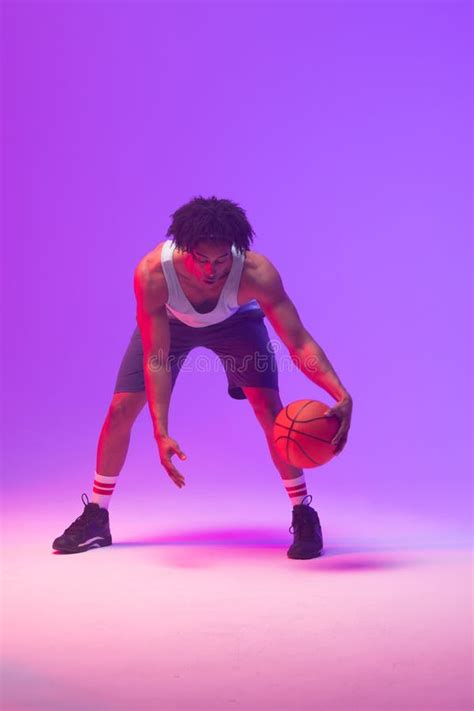 Image Of Biracial Basketball Player With Basketball On Neon Purple