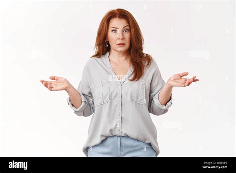 What Just Hapenned Confused Clueless Middle Aged Redhead Woman Shrugging Hands Spread Sideways