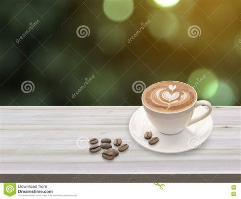Warm Cup Of Coffee Latte Art With Heart Pattern In A White Cup A Stock