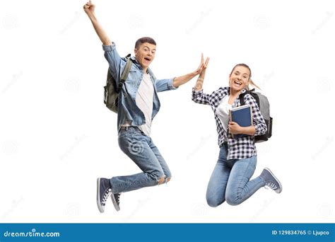 Two Overjoyed Teenage Students In Mid Air High Fiving Each Other Stock