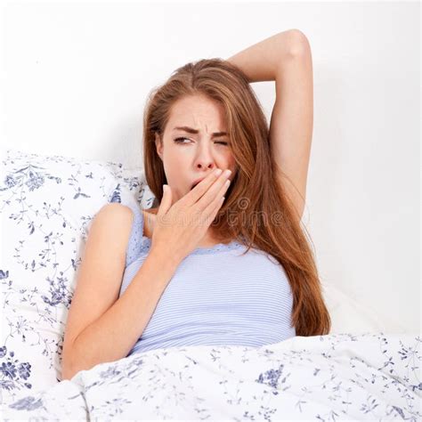 Young Attractive Woman Lying In Bed Yawing Stock Photo Image Of Face