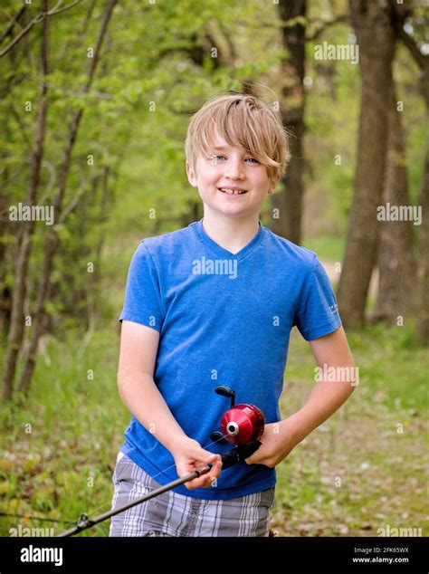 Young Boy Holding A Fishing Pole Stock Photo Alamy