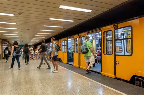 Passengers Boarding The Yellow Train Wagons Of Budapest Subway