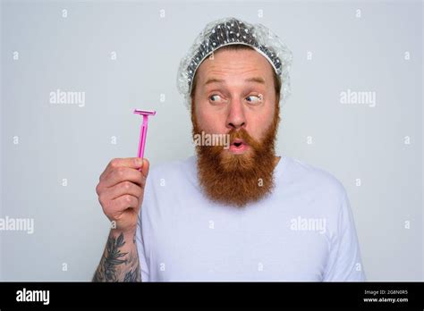 Wondered Man Adjust The Beard With A Razor Blade Stock Photo Alamy