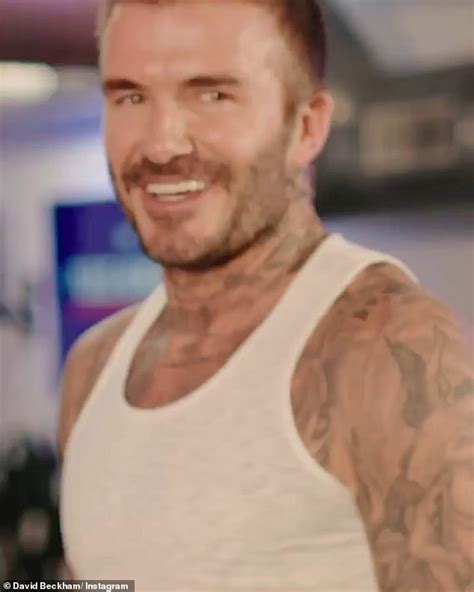 david beckham shows off his tattooed physique in a white vest as he works up a