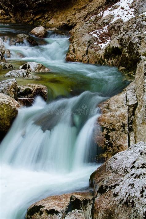 River Rocks In Smooth Satin Water Flow Of Waterfall In Wintertime Stock