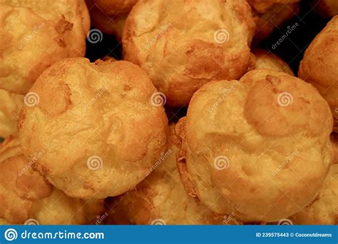 fresh baked french choux pastry balls during cooling dawn before cream filled stock image