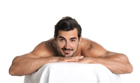 Handsome Young Man Relaxing On Massage Table Against White Background