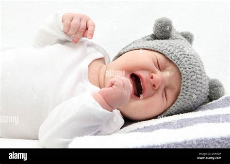 Little Baby Crying On Bed Stock Photo Alamy