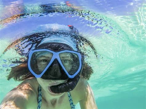 Woman Taking An Underwater Selfie While Snorkeling In Crystal Clear