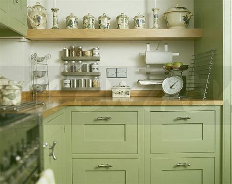26 creative open kitchen cupboards. Image: Pottery jars on beech shelf above pastel green ...