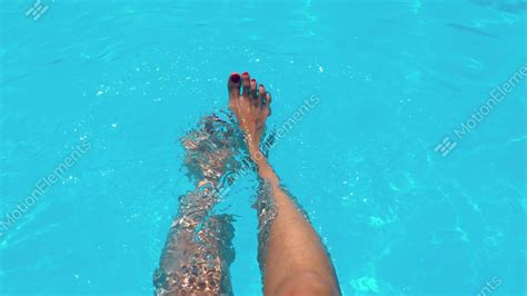 Beautiful Girl Relaxing Her Feet In Pool Water In Summer Stock Video