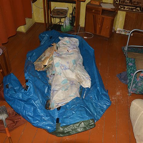 Picture Of The Corpse Inside A Bag Made Of A Construction Tarpaulin