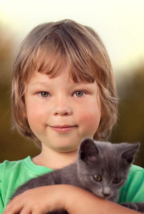 Kitten On Arm Of The Boy Outdoors Child Huge His Love Pet Stock Photo
