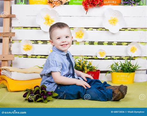 Cute Boy In A Blue Denim Shirt And Tie Jeans And Boots Stock Photo