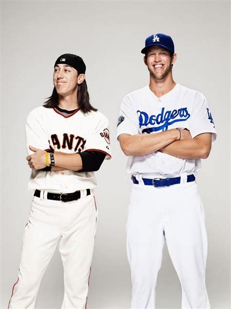 Two Baseball Players Posing For The Camera With Their Arms Crossed In