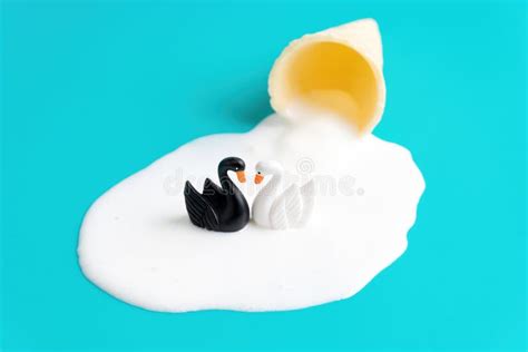 Two Swans Swimming In A Melted Ice Cream Lake Stock Photo Image Of