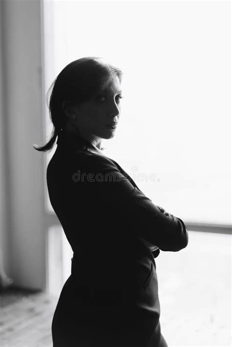 Black And White Silhouette Of A Beautiful Young Woman At Home Stock