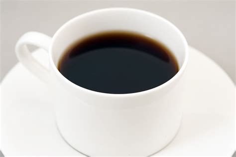 Black energizing coffee served in a white cup - Free Stock Image
