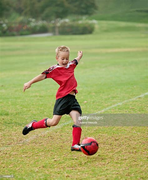 Boy Kicking Soccer Ball High Res Stock Photo Getty Images