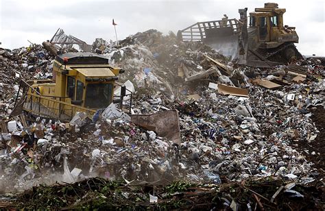 Heavy Equipment Operators Use Machinery To Compact And Shape Mountains