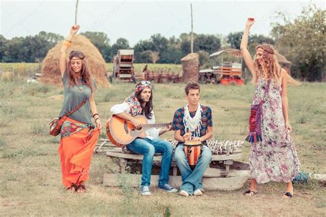 Hippie Group Playing Music And Dancing Outside Stock Photo