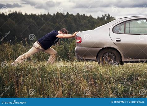 Man Pushing His Broken Car Down The Country Road Stock Image Image Of