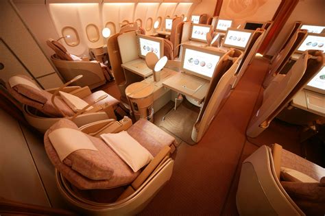 The Inside Of An Airplane With Seats And Desks