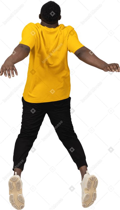 Back View Of A Jumping Young Dark Skinned Man In Yellow T Shirt