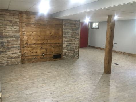 Basement Remodel Carsiding And Stone Wall Red Door Wood Pole