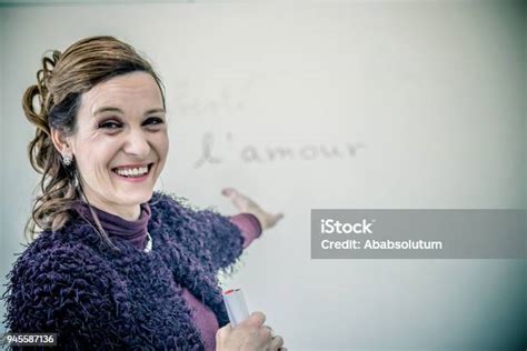 Beautiful Mature French Teacher In Purple In The Classroom Europe Stock
