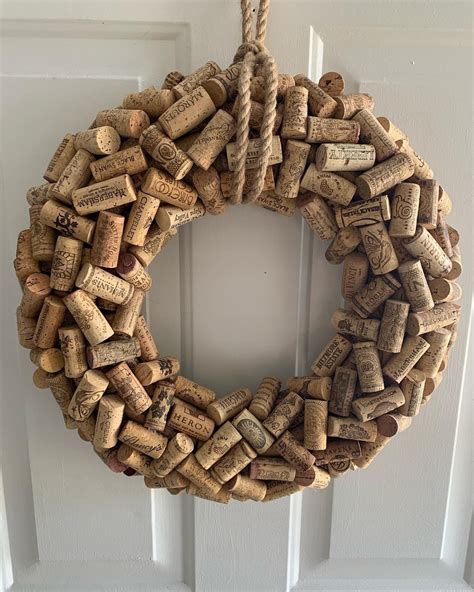 A Wreath Made Out Of Wine Corks Hanging On A Door