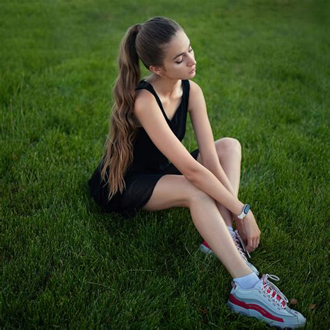 1024x1024 girl model sitting on grass long hair 4k 1024x1024 resolution hd 4k wallpapers images
