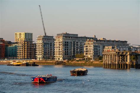 Skyline Of New Riverside Apartment Buildings With Boats Floating On The