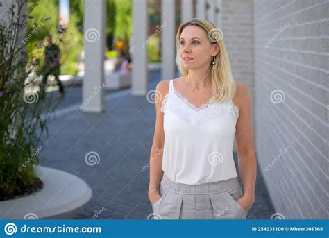 Wistful Blond Woman Looking Away With Contemplative Expression Stock