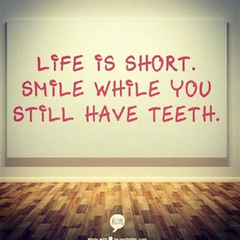A White Wall With A Red Message On It That Says Life Is Short Smile