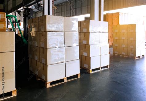 Packaging Boxes Stacked On Wooden Pallets At Storage Warehouse Supply