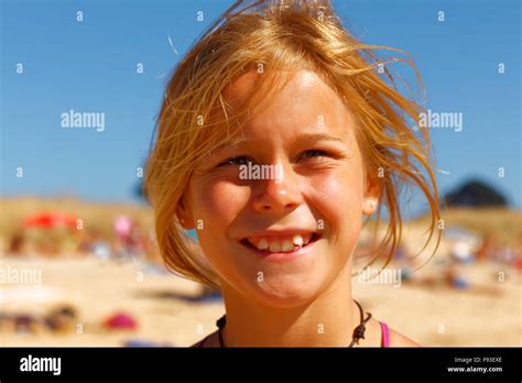 Portrait Of A Happy And Attractive 10 Years Old Girl At The Beach In