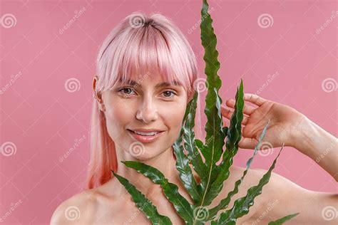 Portrait Of Beautiful Naked Woman With Pink Hair Smiling At Camera Posing With Plant Leaf