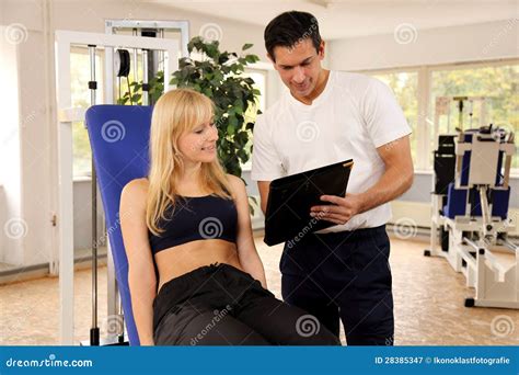 Attractive Blonde Woman And Her Trainer In A Gym Stock Image Image Of