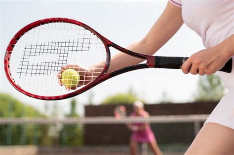 Premium Photo Female Tennis Player Holding Ball Over Racket While Going To Throw It To Playmate