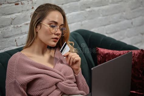 lady blogger in pink cardigan and glasses she sitting on green sofa with colorful pillows