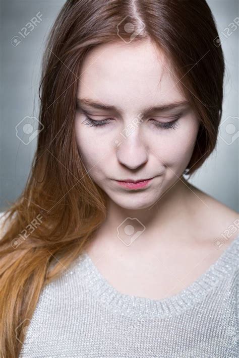 Close Shot Of Long Haired And Blue-eyed Girl's Face, Who Is Sadly ...