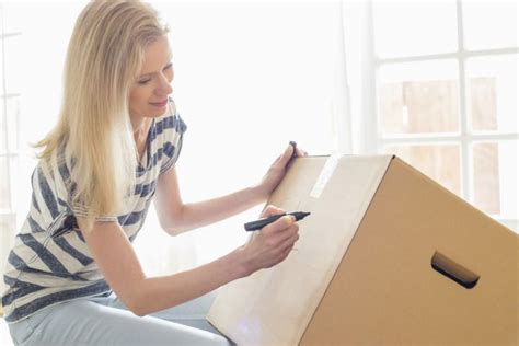 Woman Labeling Moving Box Stock Photo By ©londondeposit 138127280