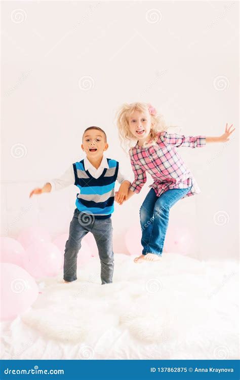 Caucasian Cute Adorable Funny Children Jumping On Bed Stock Image