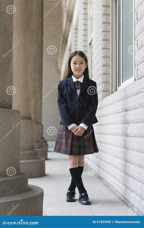 Elementary Age Schoolgirl In Uniform With Backpack Royalty Free Stock