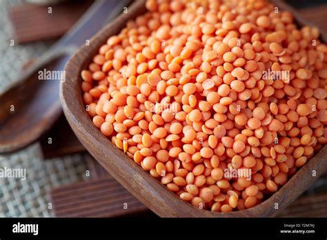Raw Uncooked Red Lentils Lens Culinaris In Wooden Bowl Stock Photo