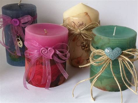 Three Different Colored Candles With Bows On Them