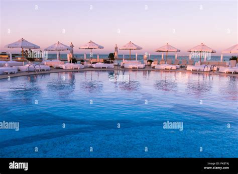 Pastel Sunset Light Over Swimming Pool And Sun Beds Stock Photo Alamy